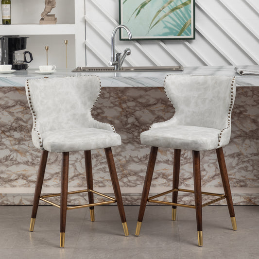 Nolani  - Set of 2 - 26" Off-White Faux Leather Tufted Counter Stools with Nailhead Trim, Walnut Legs, and Gold Footrest