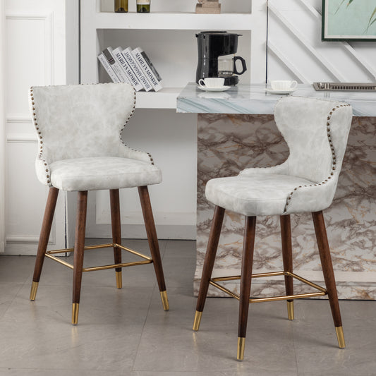 Nolani  - Set of 2 - 26" Off-White Faux Leather Tufted Counter Stools with Nailhead Trim, Walnut Legs, and Gold Footrest